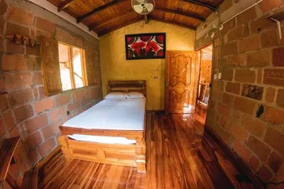 a bedroom with a bed in a brick wall at Hostal Vista Hermosa in San Rafael