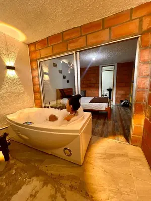 a woman sitting in a bath tub in a room at Hostal Vista Hermosa in San Rafael