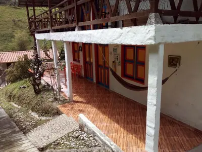 a house with colorful doors on the side of it at Hostal Encanto La Salada in Jardin