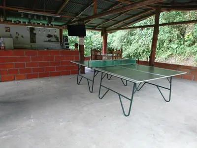 a ping pong table sitting inside of a building at Hostal Encanto La Salada in Jardin
