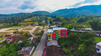 an aerial view of a city with mountains in the background at Guatapé Country House Hotel in Guatapé