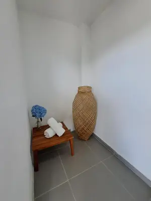 a corner of a room with a bench and a vase at Guatapé Country House Hotel in Guatapé