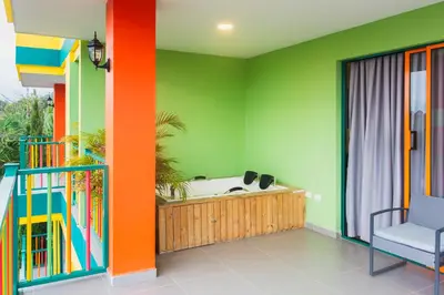 a colorful room with a bath tub in the corner at Guatapé Country House Hotel in Guatapé