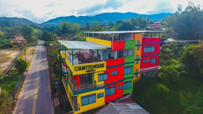 a colorful building on the side of a road at Guatapé Country House Hotel in Guatapé