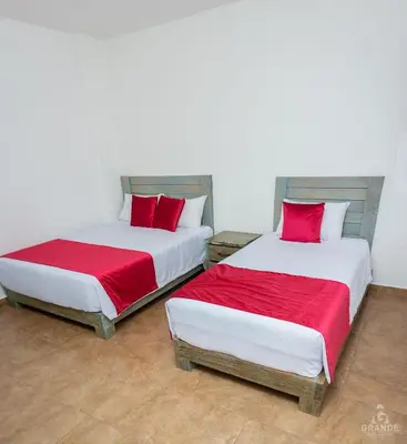 two beds sitting next to each other in a room at Hotel Madre Laura Jericó in Jericó