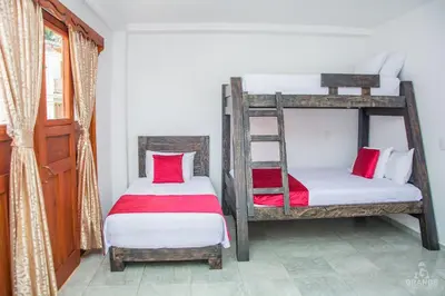 two bunk beds in a room with a window at Hotel Madre Laura Jericó in Jericó