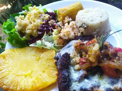 a plate of food with rice and fruit and a salad at Alojamiento Natural La Cueva de Morgan San Rafael in San Rafael