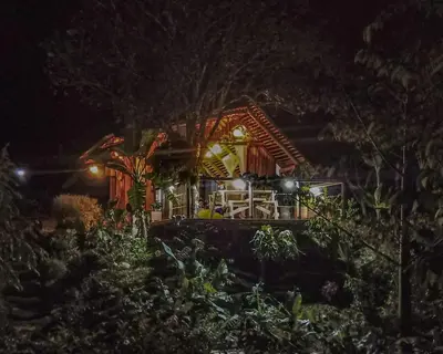 a house lit up at night with lights at Alojamiento Natural La Cueva de Morgan San Rafael in San Rafael