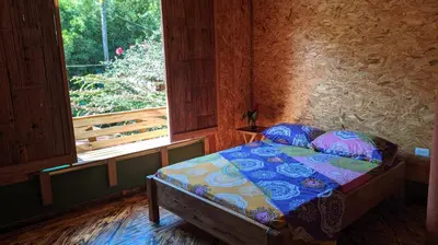 a bed in a room with a window at Alojamiento Natural La Cueva de Morgan San Rafael in San Rafael