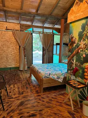 a bedroom with a bed and a painting on the wall at Alojamiento Natural La Cueva de Morgan San Rafael in San Rafael