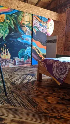 a room with a bench and a painting on the wall at Alojamiento Natural La Cueva de Morgan San Rafael in San Rafael