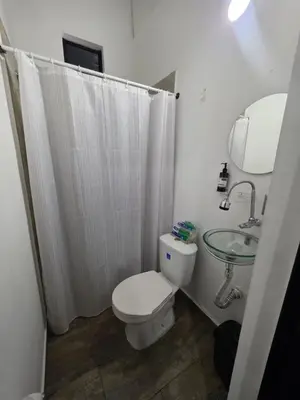 a bathroom with a toilet and a sink and a mirror at Hotel Prestige in Medellín