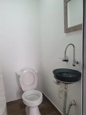 a bathroom with a toilet and a black sink at Hotel Prestige in Medellín