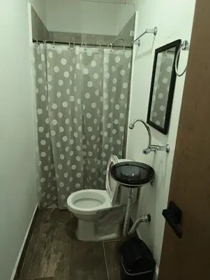 a bathroom with a toilet and a sink and a shower at Hotel Prestige in Medellín