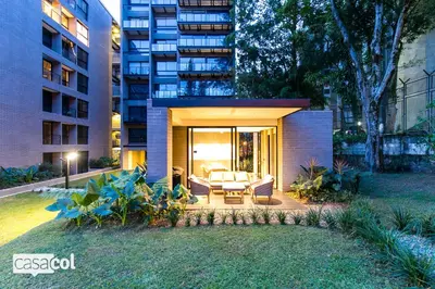 a house with a patio in front of a building at Loma Verde Aparthotel in Medellín