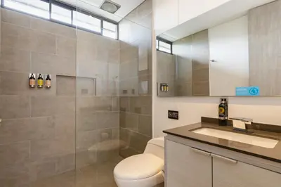 a bathroom with a toilet and a sink and a mirror at Loma Verde Aparthotel in Medellín