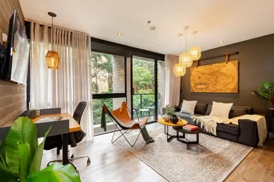 a living room with a couch and a table at Loma Verde Aparthotel in Medellín