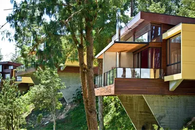 a house on a hill with a tree at Luxé Cabañas in Guatapé