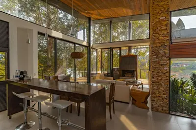 an open living room with a large table and chairs at Luxé Cabañas in Guatapé