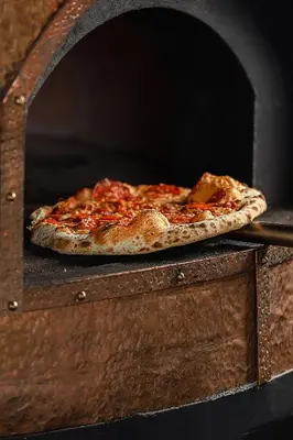 a pizza sitting on top of a pizza oven at Luxé Cabañas in Guatapé