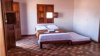 a bedroom with two beds and a window at Casa Republicana en Jericó in Jericó