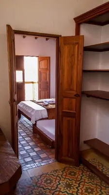 a room with two beds and an open door at Casa Republicana en Jericó in Jericó