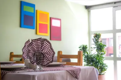 a dining room table with a table cloth on it at Hotel Portal de Milán in Manizales