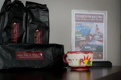 a coffee cup and a bag on a table at Hotel Portal de Milán in Manizales