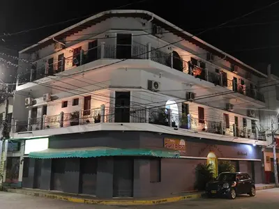 a building with a car parked in front of it at Hotel Casa de las Dos Palmas -Hotel Boutique in Puerto Berrío