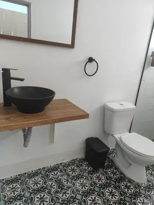 a bathroom with a black sink and a toilet at Hotel Casa de las Dos Palmas -Hotel Boutique in Puerto Berrío