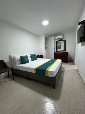 a bedroom with a bed and a television in it at Hotel Lukas in Medellín