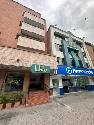 a large building with a sign in front of it at Hotel Lukas in Medellín