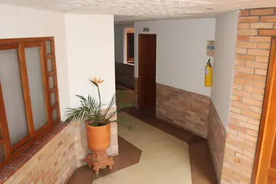 a hallway with a potted plant in a building at Hotel Torreon De Rionegro in Rionegro