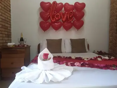 a bedroom with a bed with a bunch of heart balloons at Hotel Torreon De Rionegro in Rionegro