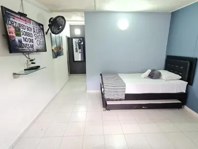 a bedroom with a bed and a tv on a wall at New Cozy Apartment in the Poblado, San Lucas in Medellín