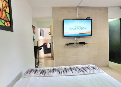 a flat screen tv on a wall in a room at New Cozy Apartment in the Poblado, San Lucas in Medellín