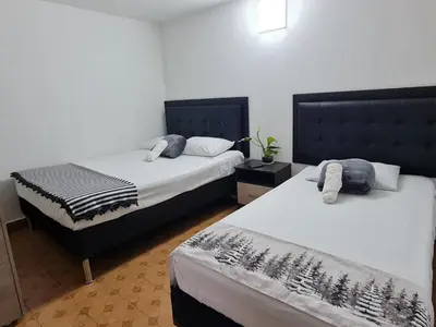 two beds in a room with two beds sidx sidx sidx sidx at New Cozy Apartment in the Poblado, San Lucas in Medellín