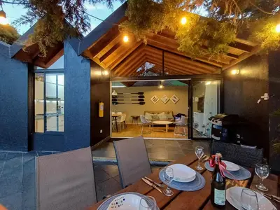 a table with plates and wine glasses on top of it at Cottage on the Lake - Cabaña privada - Guatapé - Jacuzzi in Guatapé