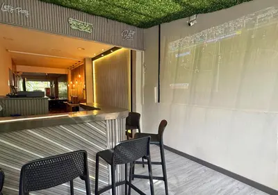 a bar with black chairs and a green ceiling at Greenview Medellin By St Hoteles in Medellín