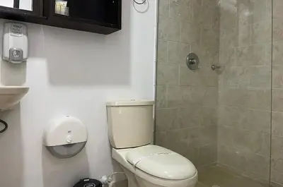 a bathroom with a toilet and a shower at Greenview Medellin By St Hoteles in Medellín