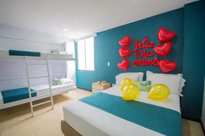 a bedroom with a bed with hearts on the wall at Greenview Medellin By St Hoteles in Medellín