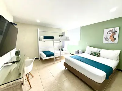 a bedroom with a bed and a bunk bed at Greenview Medellin By St Hoteles in Medellín