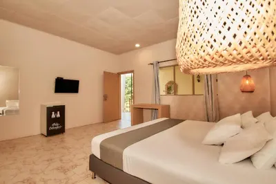 a bedroom with a large bed and a television at La Iguana de Santa Fe by Bernalo Hotels in Santa Fe de Antioquia