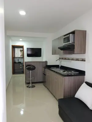a kitchen with a stove and a counter top at Apartaestudio Centro Comercial la Central in Medellín
