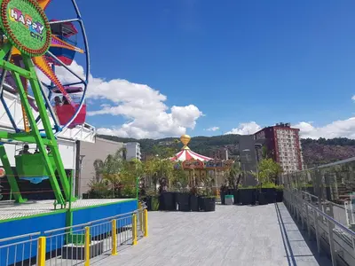a carnival ride with a ferris wheel and a carnival tent at Apartaestudio Centro Comercial la Central in Medellín