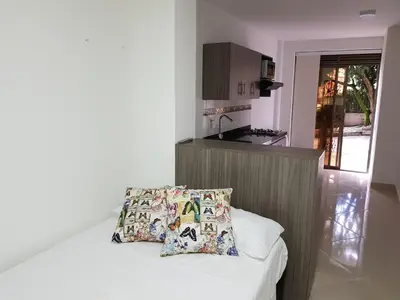 a kitchen with a bed with a pillow on it at Apartaestudio Centro Comercial la Central in Medellín
