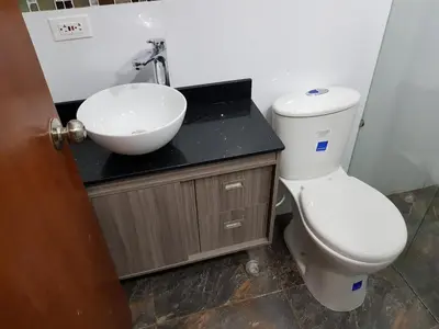 a bathroom with a white sink and a toilet at Apartaestudio Centro Comercial la Central in Medellín