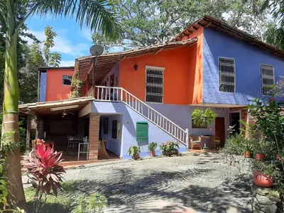 an orange and white house with a courtyard at Selvablanca Hostel in San Jerónimo