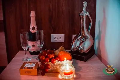a table with wine glasses and fruit on it at Hotel La Roca San Rafael in San Rafael