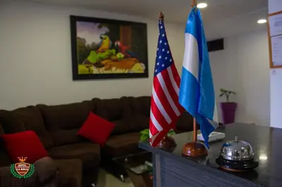 two flags sitting on a table next to a couch at Hotel La Roca San Rafael in San Rafael